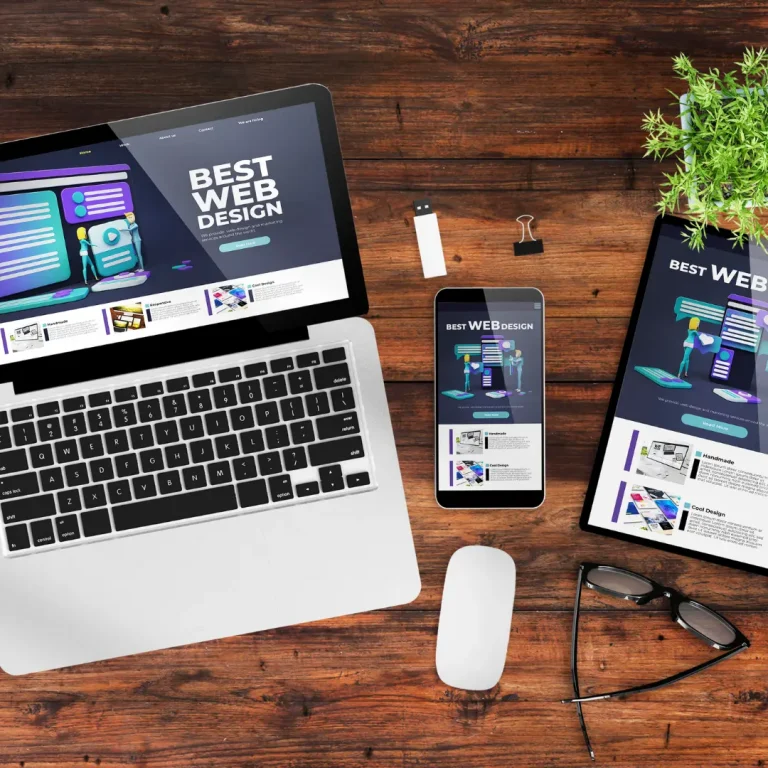 responsive website design displayed across laptop tablet and mobile devices on a desk